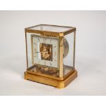 A JAEGER LE COULTRE BURNISHED AND BRUSHED MATT GILT BRASS CASED ATMOS CLOCK, with square dial,