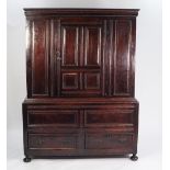 LATE SEVENTEENTH CENTURY PANELLED OAK TWO PART CUPBOARD, the upper section with moulded cornice