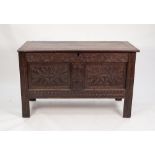 LATE SEVENTEENTH/ EARLY EIGHTEENTH CENTURY CARVED OAK COFFER, the plank top above a twin panelled