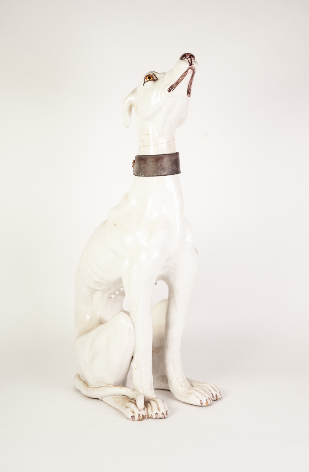 MODERN ITALIAN WHITE TIN GLAZED POTTERY MODEL OF A SEATED FEMALE GREYHOUND WITH LEATHER COLLAR,