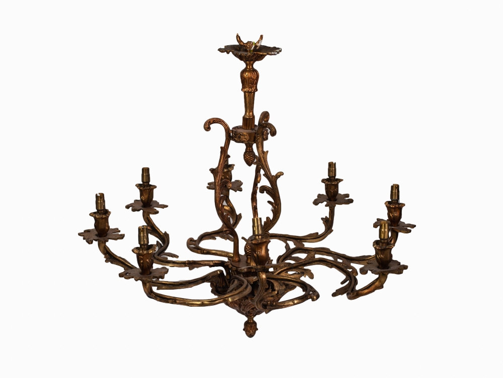 ROCOCO STYLE EIGHT LIGHT GILT METAL ELECTROLIER, with leaf capped scroll arms and pineapple finials,