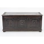 A LARGE SEVENTEENTH CENTURY OAK COFFER, with three carved panels (later top) 54 1/2" (139cm) long,