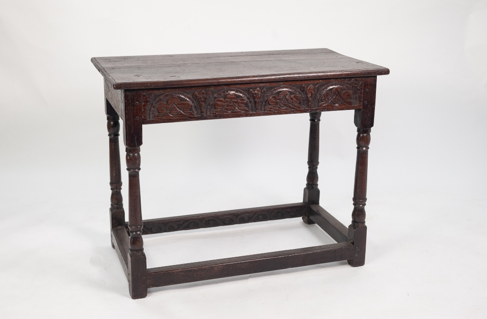 17th CENTURY STYLE OAK SIDE TABLE, the plank top with moulded edge above a front carved frieze,