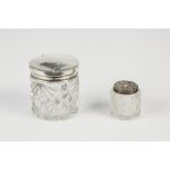 TWO EDWARD VII AND LATER CUT GLASS TOILET JARS WITH PULL-OFF SILVER LIDS, 1 ½" (3.8cm) high,