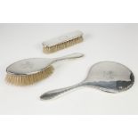 LADY'S SILVER DRESSING TABLE SET OF THREE PIECES, viz a hand mirror with engraved border and