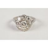 18CT GOLD AND DIAMOND DAISY CLUSTER RING, the raised centre diamond approx 3/4ct and surround of