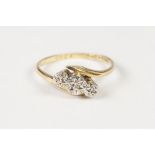 18ct GOLD AND PLATINUM CROSS OVER RING, with three tiny diamonds in deceptive settings, 2.3gms, ring