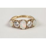 VICTORIAN 18ct GOLD, DIAMOND AND OPAL RING, with a carved setting of three oval opals, two round old