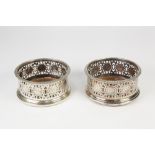 PAIR OF ELECTROPLATED WINE BOTTLE COASTERS, each of typical form with fancy scroll pierced