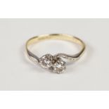 18ct GOLD AND PLATINUM CROSS OVER RING, set with two round brilliant cut diamonds, each approx 1/