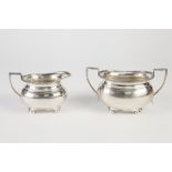GEROGIAN STYLE SILVER CREAM JUG AND MATCHING TWO HANDLE SUCRIER of squat oval form, the everted rims