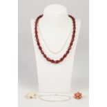 SINGLE STRAND NECKLACE OF RED AMBER FACETED GRADUATED OVAL BEADS, 15" long, PINK CORAL DAISY CLUSTER