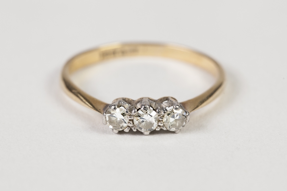 AN 18ct GOLD AND PLATINUM RING, claw set with a row of three diamonds, approx 1/3ct in total, 1.7gms