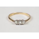 AN 18ct GOLD AND PLATINUM RING, claw set with a row of three diamonds, approx 1/3ct in total, 1.7gms