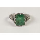 AN ART DECO WHITE GOLD, EMERALD AND DIAMOND RING, set with an oblong emerald, approx 11mm x 9mm, the