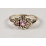 9ct GOLD RING, SET WITH THREE AMETHYSTS, and four tiny diamonds, 1.7gms