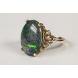 18ct GOLD RING with an oval green iridescent stone in a four claw setting, 4.5 gms, ring size 'N'