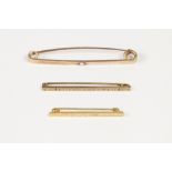 TWO 9ct GOLD TIE PIN AND A LARGE SAFETY PIN TYPE LARGE TIE PIN set with centre white onyx (tests