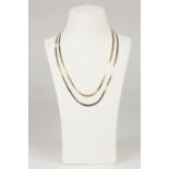 TWO ITALIAN GOLD COLOURED METAL FLAT SNAKE PATTERN CHAIN NECKLACES, 17" (43.2cm) and 19" (48.2cm)