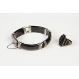 SILVER COLOURED METAL AND ONYX BRACELET of four curved oblong links/sections and a SIMILAR RING of