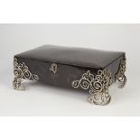 AN EDWARDIAN SILVER MOUNTED TORTOISESHELL JEWELLERY BOX, The openwork corner mounts and felt form of