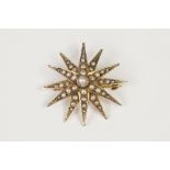 EARLY TWENTIETH CENTURY 9ct GOLD AND SEED PEARL STAR/BROOCH PENDANT, 1 1/8" diameter, 3.7gms