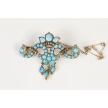 VICTORIAN GOLD COLOURED METAL WING SHAPED SCROLLED BROOCH set with numerous turquoises and rose