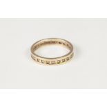 9ct GOLD AND WHITE STONE ETERNITY RING; A STAINLESS STEEL RING; a RELIGIOUS RING; AND A MODERN