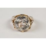 VICTORIAN GOLD RING, with an old cut cushion shaped citrine in a setting of eight leaf shaped