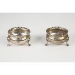 PAIR LATE VICTORIAN CIRCULAR SILVER OPEN SALTS with applied 'C' scroll border , cushion sides and