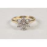 18ct GOLD AND DIAMOND DAISY CLUSTER RING claw set with seven round brilliant cut diamonds,