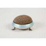 GEORGE V SILVER AND BLUE GUILLOCHE ENAMELLED PIN CUSHION, of circular form with three scroll feet,