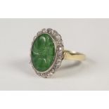 18ct GOLD, GREEN HARDSTONE AND DIAMOND OVAL CLUSTER RING, set with a large carved green hardstone