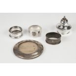 THREE VARIOUS SILVER NAPKIN RINGS two having foliate scroll engraved decoration the other engine