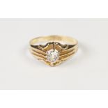 18ct GOLD RING SET WITH A ROUND BRILLIANT CUT SOLITAIRE DIAMOND, with fluted shoulders, approx .