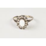 SILVER, OPAL AND WHITE STONE OVAL CLUSTER RING, with centre oval opal and surround of white stones