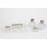 MATCHED FIVE PIECE GEORGE V SILVER MOUNTED CUT GLASS DRESSING TABLE SET, comprising: PAIR OF