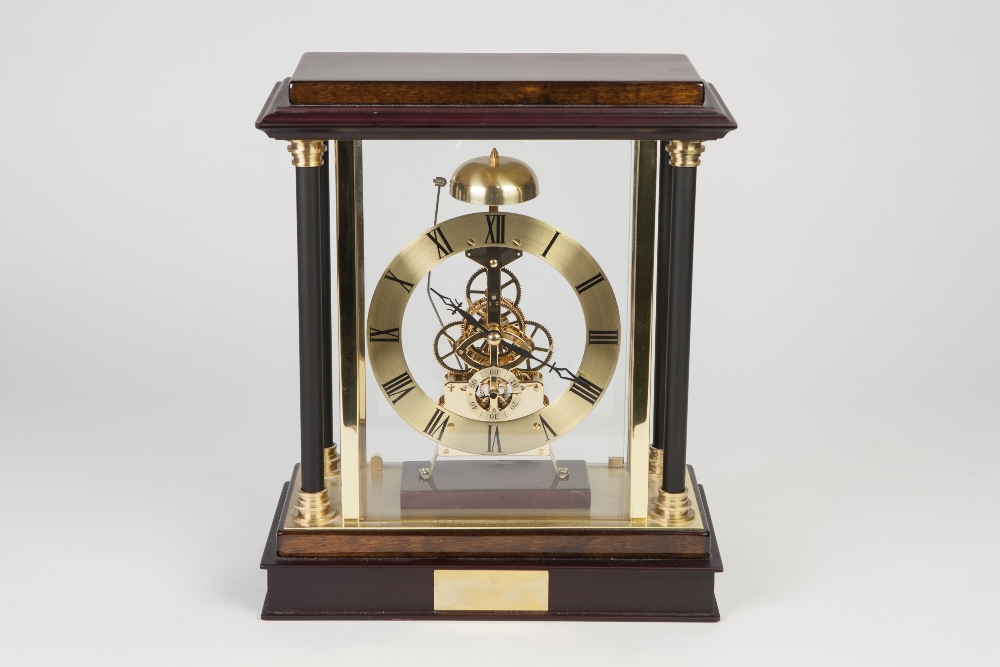 MODERN SKELETON CLOCK, with battery operated movement striking on a bell surmounting and having a