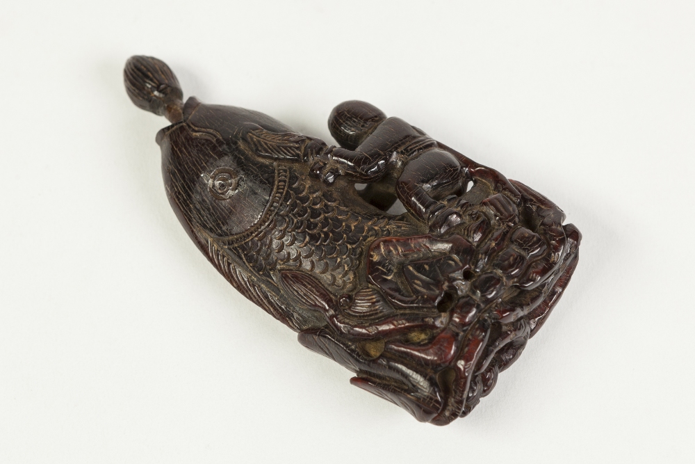 AN AGED CHINESE QING DYNASTY CARVED HORN SNUFF BOTTLE, formed of a small figure astride a carp - Image 2 of 2