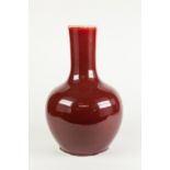 CHINESE SANG DE BOUEF GLAZED PORCELAIN VASE, of baluster form with tall, slightly tapering neck, 14"