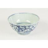 A CHINESE CHING DYNASTY PORCELAIN DEEP BOWL, coarsely painted in underglaze blue, the well with a