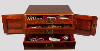 EDWARDIAN OAK THREE DRAWER CANTEEN NOW HOUSING AN ASSORTMENT OF NON-ASSOCIATED PLATED CUTLERY,