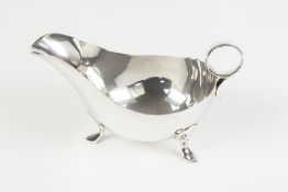 A TWENTIETH CENTURY SILVER SAUCE BOAT with ring handle, on three pad feet, Sheffield 1944, 8oz