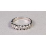 WHITE METAL RING COLLET SET WITH A ROW OF SEVEN SMALL DIAMONDS GRADUATING FROM THE CENTRE, 3.6