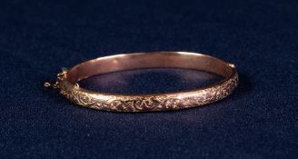 LATE VICTORIAN 9ct GOLD HOLLOW BANGLE, hinge opening with foliate scroll engraved top, Birmingham