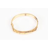 EDWARDIAN 9ct GOLD HOLLOW BANGLE, hinge opening, the top with raised lozenge shaped panel star set