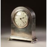 INTER-WAR YEARS ENGINE TURNED SILVER CASED DOME-TOP MANTEL CLOCK, standing on compressed ball