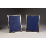 A PAIR OF APSREY, LONDON PLAIN SILVER RECTANGULAR PHOTOGRAPH FRAMES, with easel support wooden