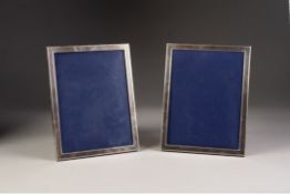 A PAIR OF APSREY, LONDON PLAIN SILVER RECTANGULAR PHOTOGRAPH FRAMES, with easel support wooden