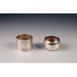 TWO SILVER NAPKIN RINGS, one engine turned, Sheffield 1935, the other floral engraved, Sheffield